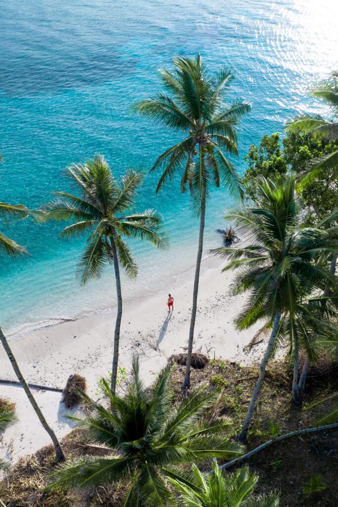 aerial view of man standing on beach on masare island, sitaro, indonesia